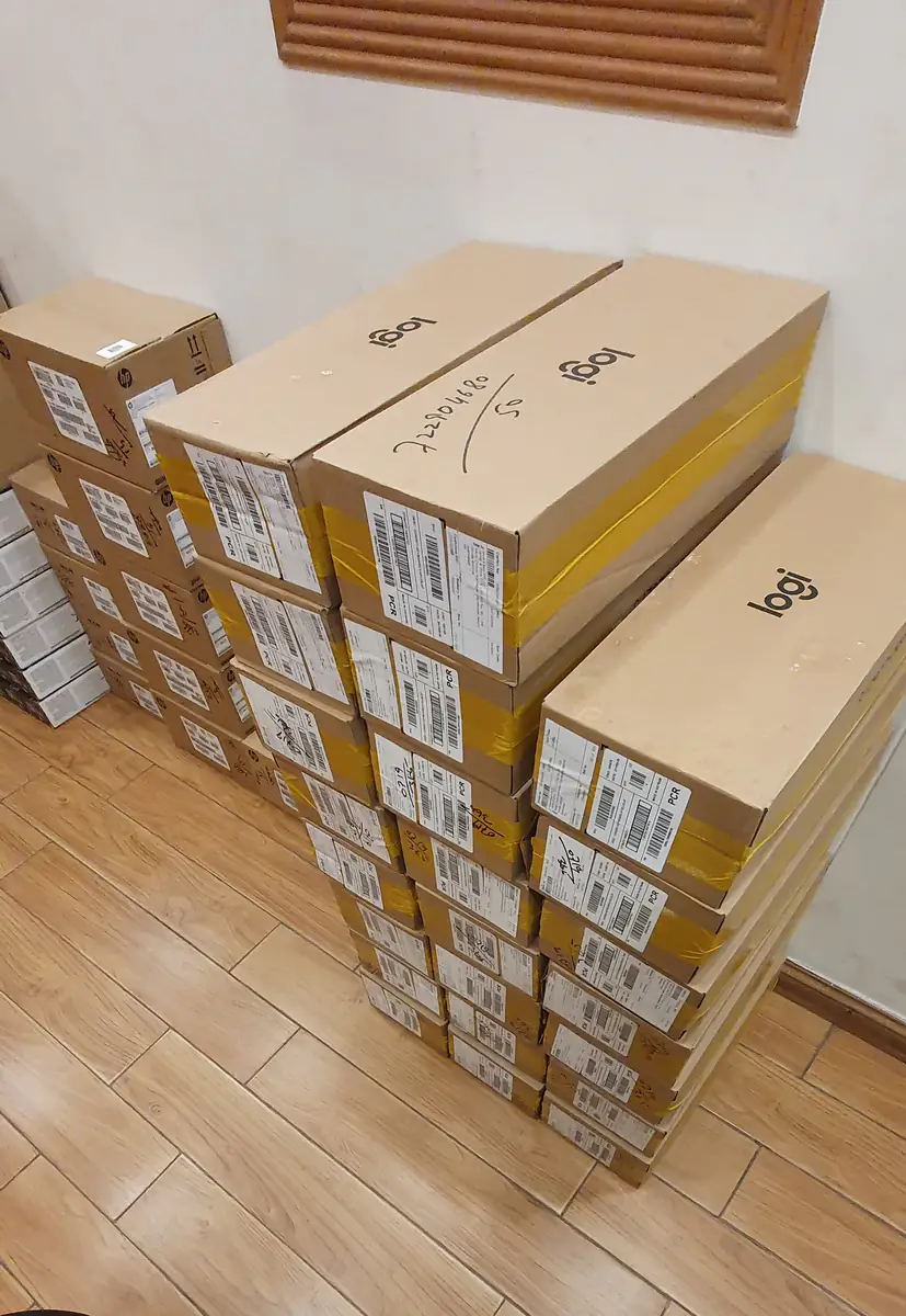 Stacked Logitech cartons with shipping labels, taped and ready for dispatch