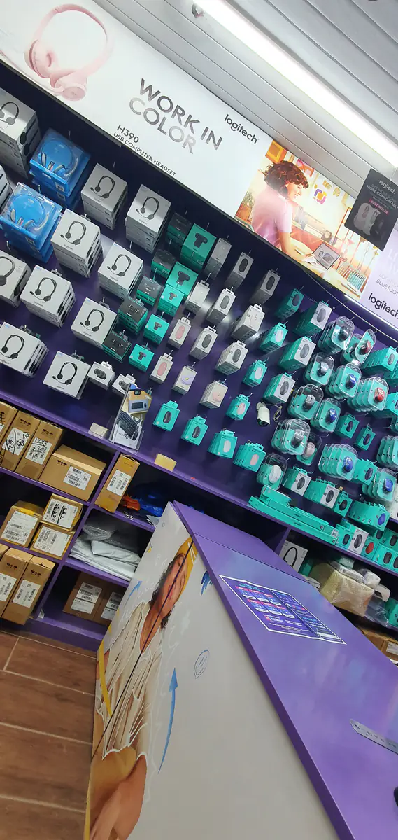 Logitech headsets, webcams and mice in sealed boxes on our display wall